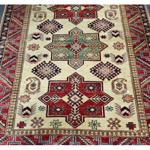 917 - A contemporary Turkish Caucasian design cream/red rug, triple pole lozenge, 180 cm x 148 cm