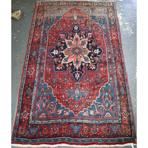 924 - A fine old Persian hand-made Bidjar carpet, the blue and red ground centred by a floral medallion, 2... 