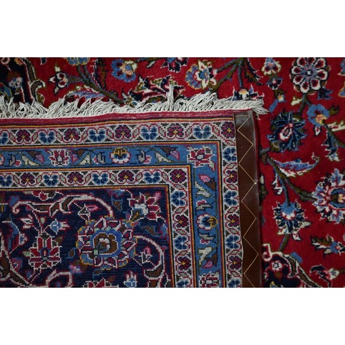 926 - A Persian Kashan red ground carpet, traditional floral design, 348 cm x 248 cm