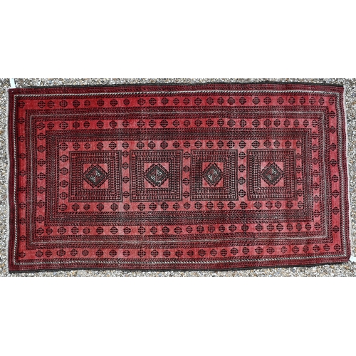 929 - A fine old Afghan Belouch rug, the faded soft red ground with geometric designs in blue/black, 190 c... 