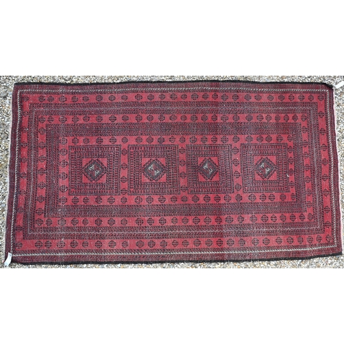 929 - A fine old Afghan Belouch rug, the faded soft red ground with geometric designs in blue/black, 190 c... 