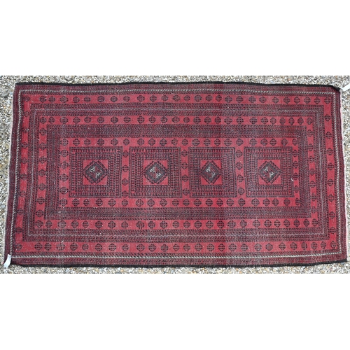 929 - A fine old Afghan Belouch rug, the faded soft red ground with geometric designs in blue/black, 190 c... 