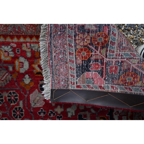 931 - A contemporary Persian Sarouk rug, centred by a diamond lozenge on red ground, 210 cm x 130 cm