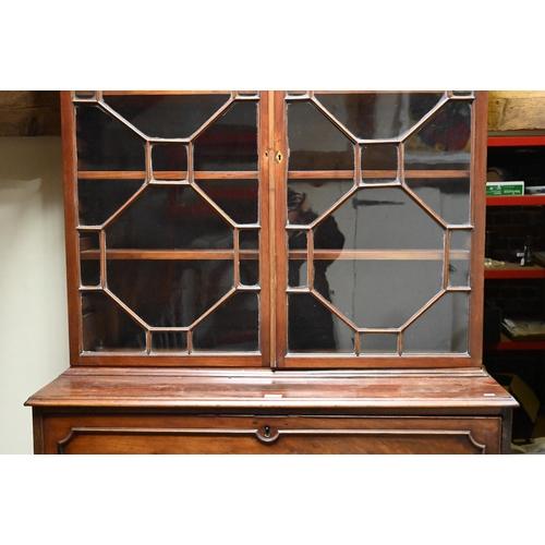 934 - A George III mahogany secretaire library bookcase, the pair of astragal glazed cabinet doors enclosi... 