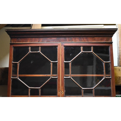 934 - A George III mahogany secretaire library bookcase, the pair of astragal glazed cabinet doors enclosi... 