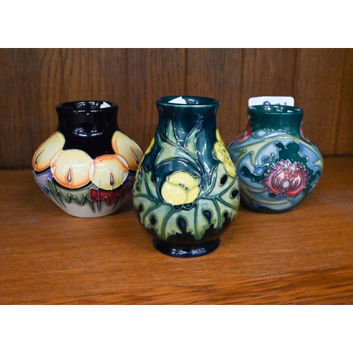 109 - Three Moorcroft small vases, decorated with fruit and flowers, 9.5/8 cm high