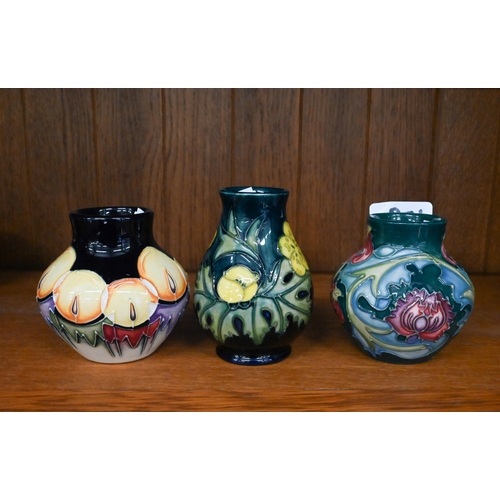 109 - Three Moorcroft small vases, decorated with fruit and flowers, 9.5/8 cm high