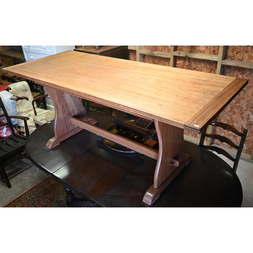 378 - A vintage African mahogany trestle dining table raised on shaped ends united by a pegged stretcher, ... 