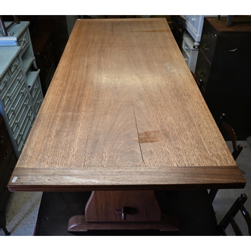 378 - A vintage African mahogany trestle dining table raised on shaped ends united by a pegged stretcher, ... 