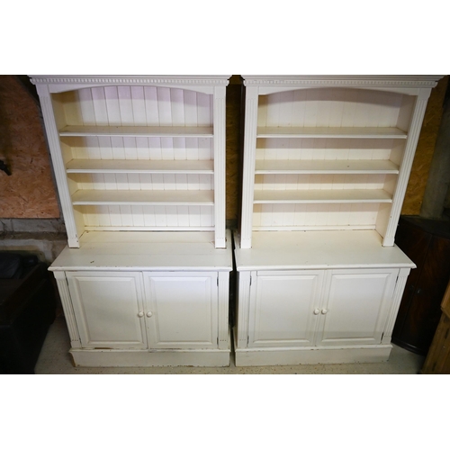 384 - A pair of painted pine library open bookcases, the four tier upper over a pair of cupboards, on plin... 