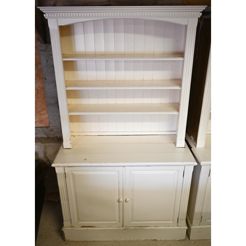 384 - A pair of painted pine library open bookcases, the four tier upper over a pair of cupboards, on plin... 