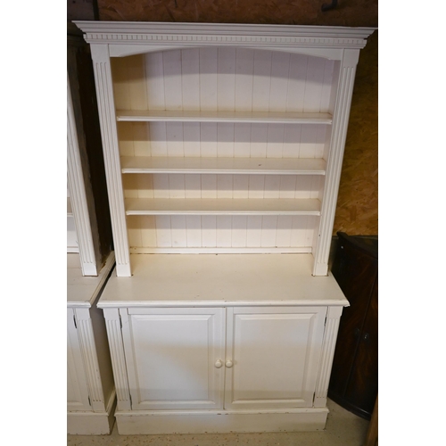 384 - A pair of painted pine library open bookcases, the four tier upper over a pair of cupboards, on plin... 