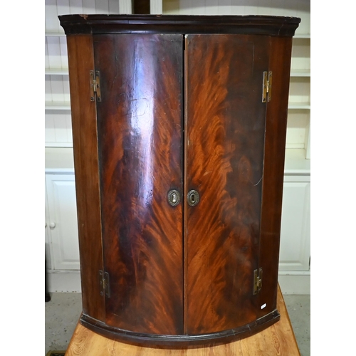 385 - #An 18th century flame mahogany barrel corner cupboard