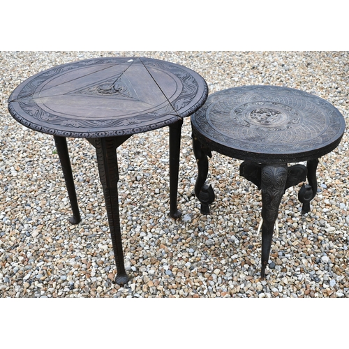 387 - An old carved Indian hardwood low circular tripod 'elephant' table, 59 cm dia. x 59 cm h, to/w a car... 