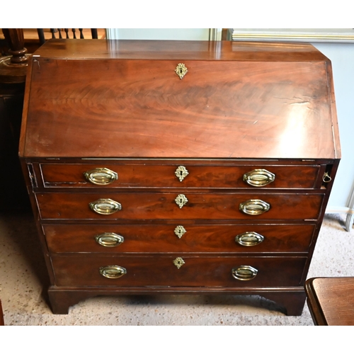 401 - A George III mahogany bureau with fitted interior over four long graduated drawers on shaped bracket... 