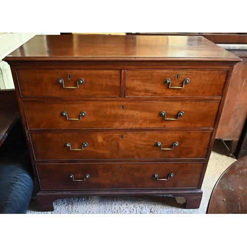 402 - A 19th century mahogany chest of two short over three long drawers with brass fittings on shaped bra... 