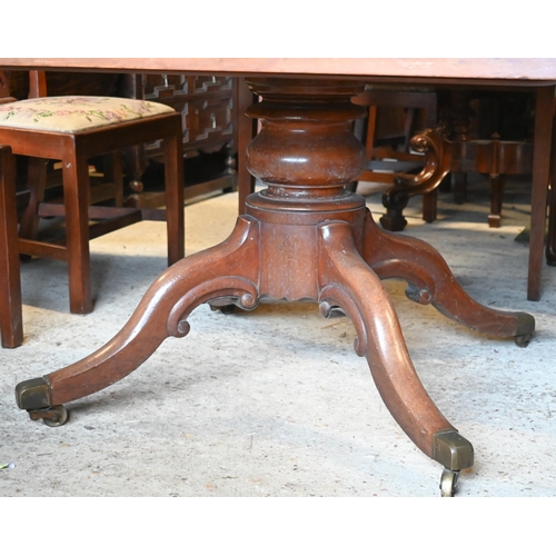 412 - A Victorian mahogany breakfast table, the rectangular tilt top raised on a turned support to four le... 