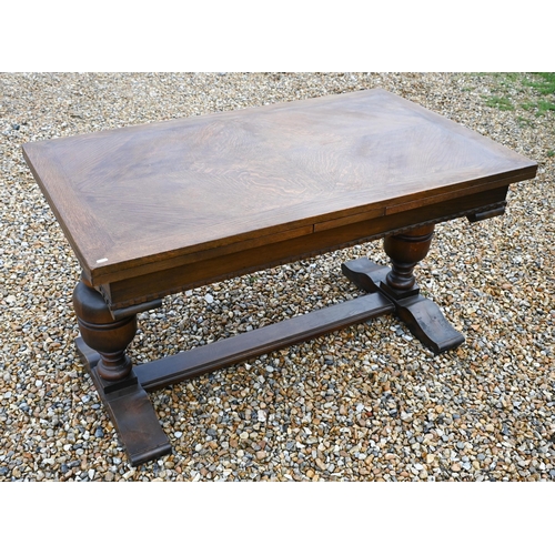 414 - An oak draw-leaf dining table raised on baluster turned ends united by a centre stretcher, 135 (247 ... 