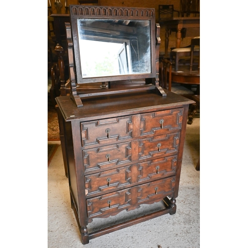 417 - An antique oak chest of four long drawers with applied geometric moulding in the Jacobean style, rai... 