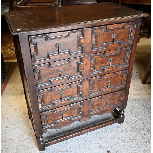 417 - An antique oak chest of four long drawers with applied geometric moulding in the Jacobean style, rai... 