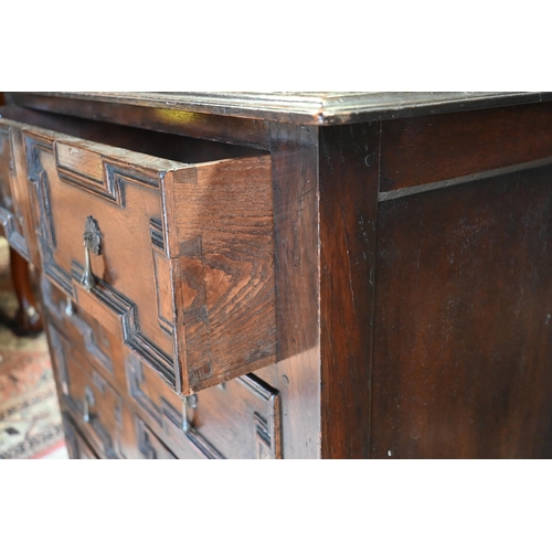 417 - An antique oak chest of four long drawers with applied geometric moulding in the Jacobean style, rai... 