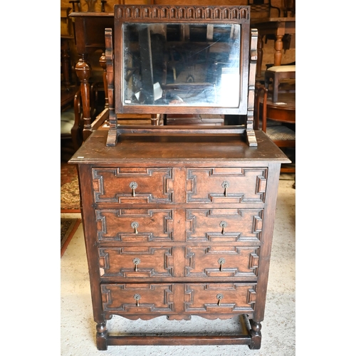 417 - An antique oak chest of four long drawers with applied geometric moulding in the Jacobean style, rai... 