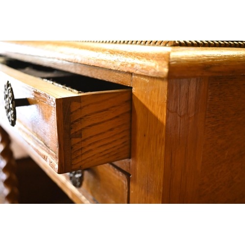 420 - An old golden oak two drawer side table - the drawers fitted for a canteen of cutlery, on baluster t... 