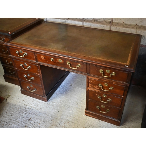 421 - A Victorian mahogany twin pedestal desk with an arrangement of nine drawers with oversize brass fitt... 