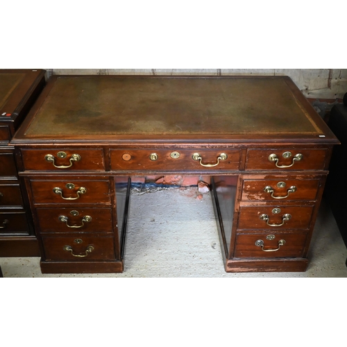 421 - A Victorian mahogany twin pedestal desk with an arrangement of nine drawers with oversize brass fitt... 