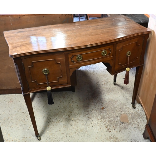 429 - A late Victorian mahogany serpentine kneehole side table/desk, on square tapered legs to ceramic cas... 