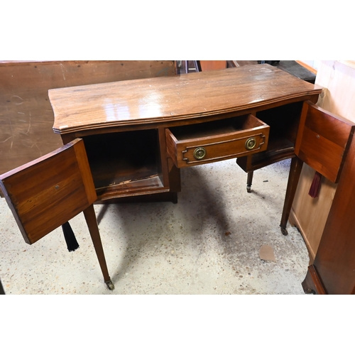 429 - A late Victorian mahogany serpentine kneehole side table/desk, on square tapered legs to ceramic cas... 