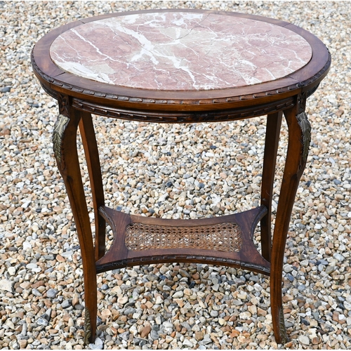 431 - #An old continental oval centre table with inset marble top over a cane panelled under-tier, 68 x 50... 