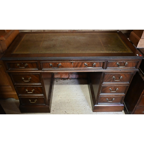 440 - A Victorian style mahogany twin pedestal desk with green leather top over an arrangement of nine dra... 