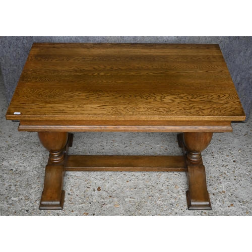 441 - #An old golden oak coffee table raised on baluster turned ends united by a centre stretcher, 88 x 56... 