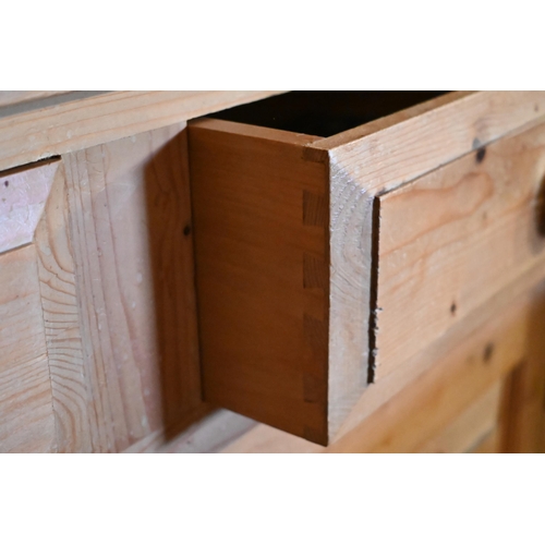 442 - A pine cottage dresser, the three tier rack over two drawers and pair of cupboards on a wavy plinth ... 