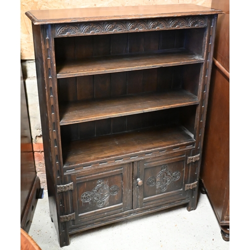 447 - An 18th century style oak part lunette carved open bookcase with pair of cupboard doors to base, on ... 