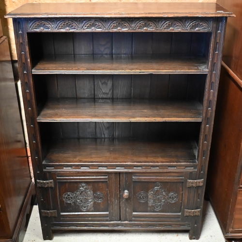 447 - An 18th century style oak part lunette carved open bookcase with pair of cupboard doors to base, on ... 