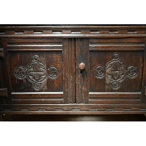 447 - An 18th century style oak part lunette carved open bookcase with pair of cupboard doors to base, on ... 