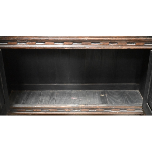 447 - An 18th century style oak part lunette carved open bookcase with pair of cupboard doors to base, on ... 