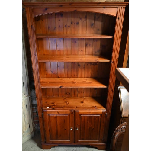 449 - A Ducal pine bookcase/cupboard, 100 x 28 x 189 cm high