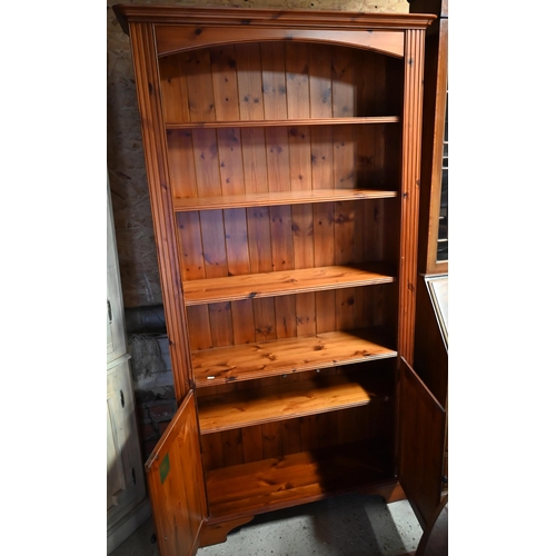 449 - A Ducal pine bookcase/cupboard, 100 x 28 x 189 cm high