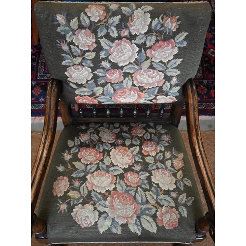 468 - A Continental stained beech open armchair with scroll arms and floral embroidered back and seat