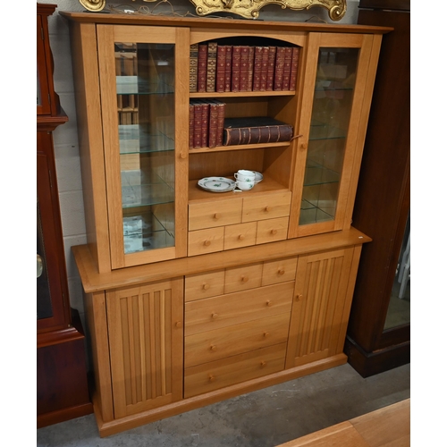 473 - A light oak wall unit with six drawers over two cupboards, with glazed doors revealing shelves, 150 ... 