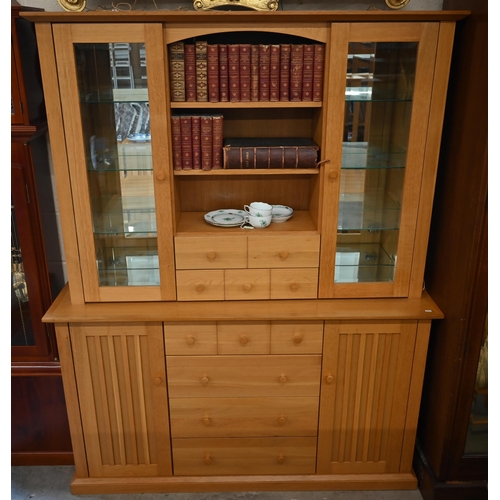 473 - A light oak wall unit with six drawers over two cupboards, with glazed doors revealing shelves, 150 ... 