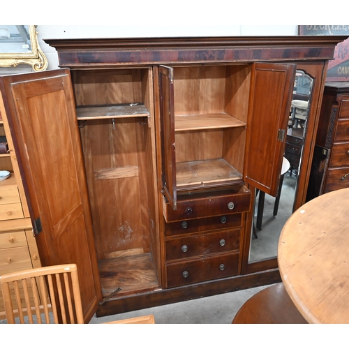 486 - A Victorian inlaid mahogany triple wardrobe with mirrored doors flanking cupboard and four drawers, ... 