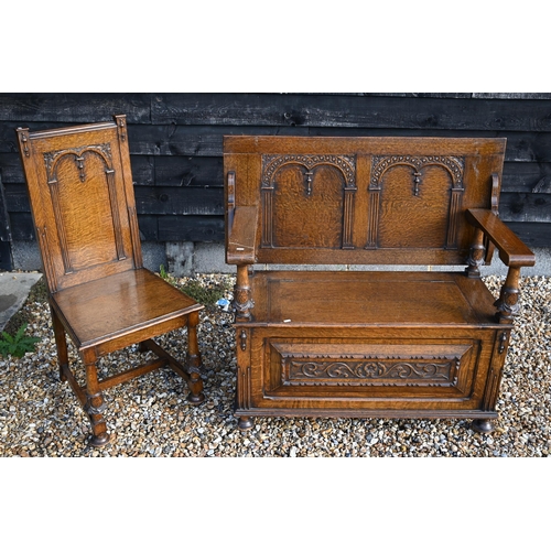 495 - A good quality carved oak monk's bench with carved supports, 107 cm wide, to/w a matching hallchair ... 