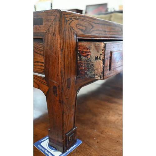 500 - A Chinese elm low table with four frieze drawers on sroll-carved supports, 141 x 43 x 33 cm high