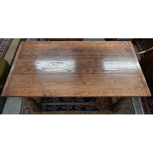 503 - A reproduction oak refectory dining table, three-plank cleated top, one end with sliding supports fo... 