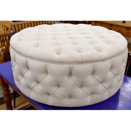 508 - A large circular button upholstered centre stool, ivory fabric upholstery on stained hardwood plinth... 