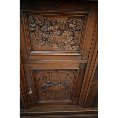 513 - Contemporary heavy quality Flemish oak side cabinet with central carved panel doors flanked by long ... 